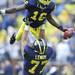 Michigan sophomore quarterback Denard Robinson is lifted into the air by sophomore offensive lineman Taylor Lewan during pre game against Massachusetts at Michigan Stadium on Saturday. Melanie Maxwell I AnnArbor.com